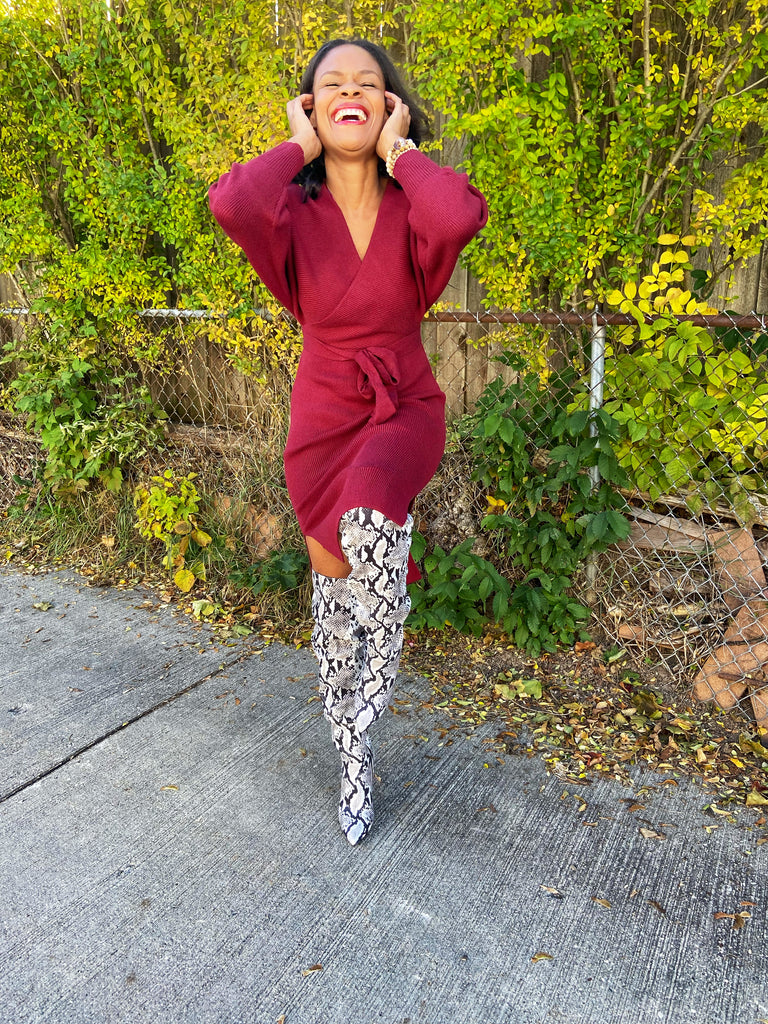 ribbed knit burgundy long sleeve sweater dress with side slits and a v neck with a waist tie belt
